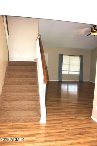 a view of entryway and hall with wooden floor