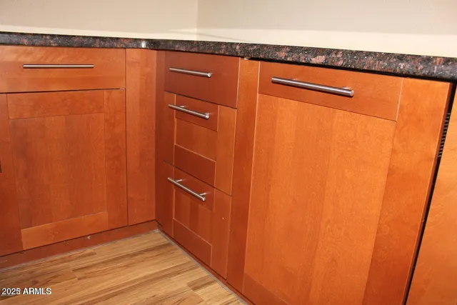 a view of a storage and utility room with wooden floor