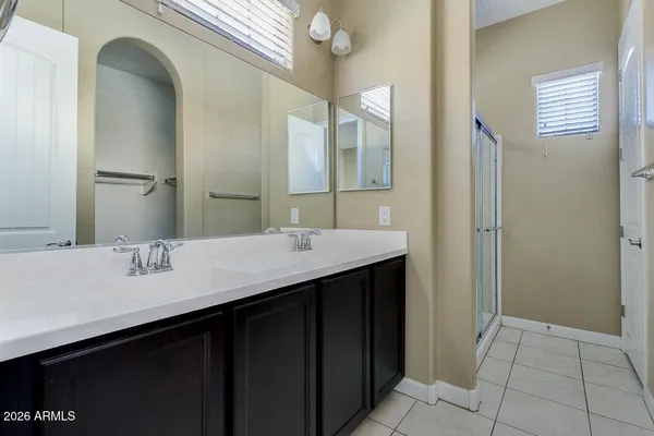 a bathroom with a double vanity sink and a mirror