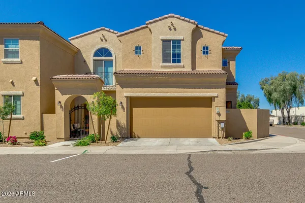 a front view of a house with a yard and a garage