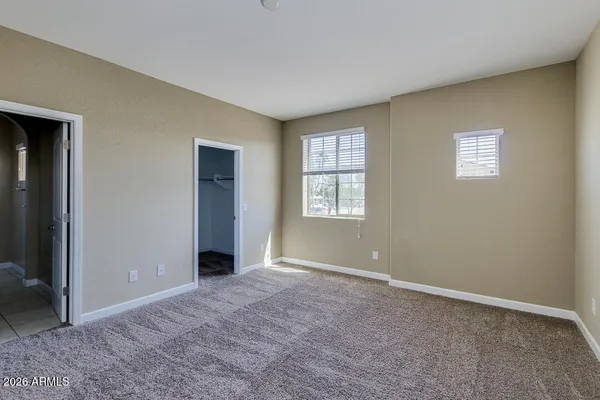 an empty room with windows and closet