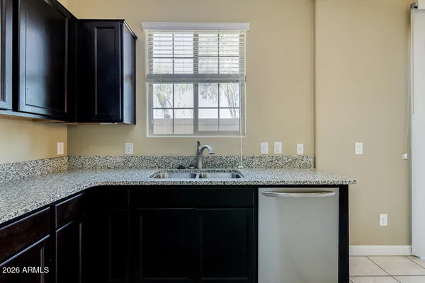 a kitchen with granite countertop a sink and a window