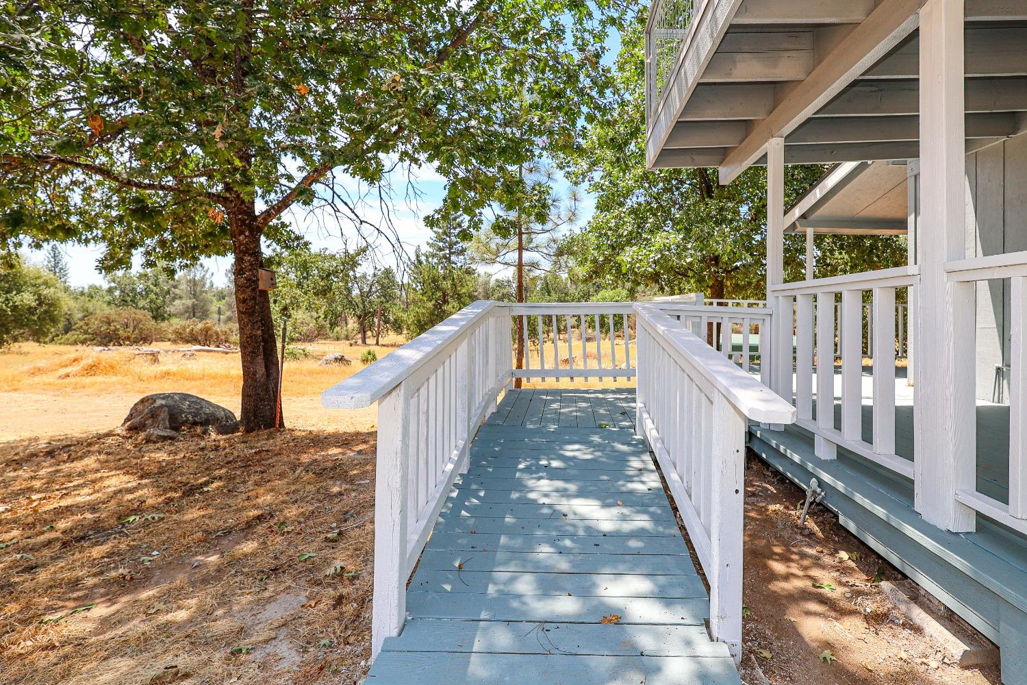 5240 Tiptop Road Mariposa, CA 95338 - Photo 11 of 71 a view of a pathway with a wrought fence