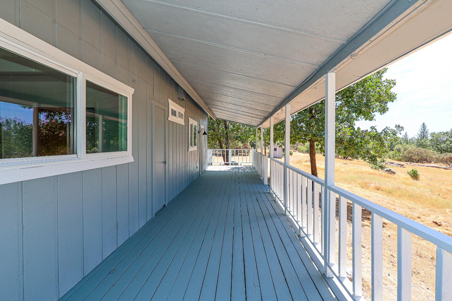 5240 Tiptop Road Mariposa, CA 95338 - Photo 8 of 71 a view of a porch with wooden floor and outdoor space