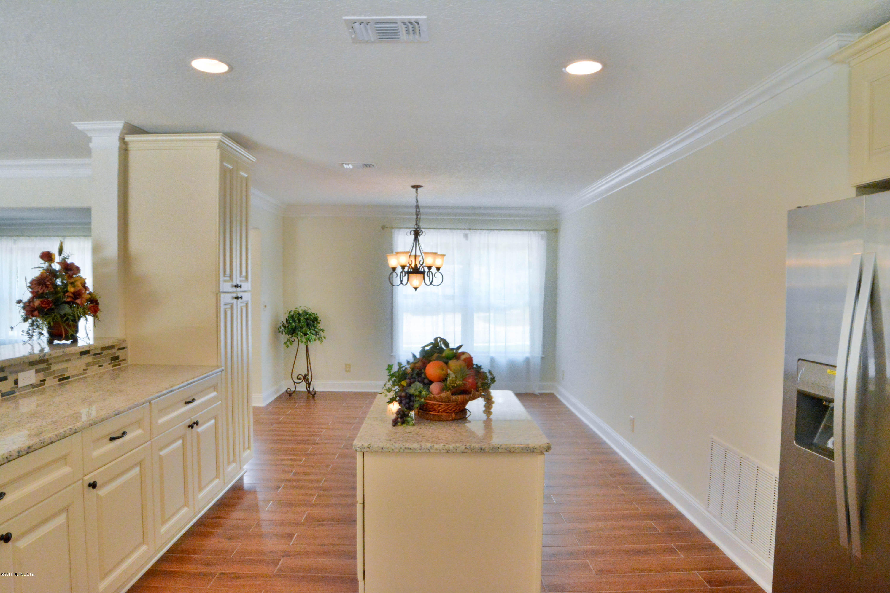 6717 West Fincannon Road Jacksonville, FL 32277 - Photo 13 of 32 a hallway with mirror and window