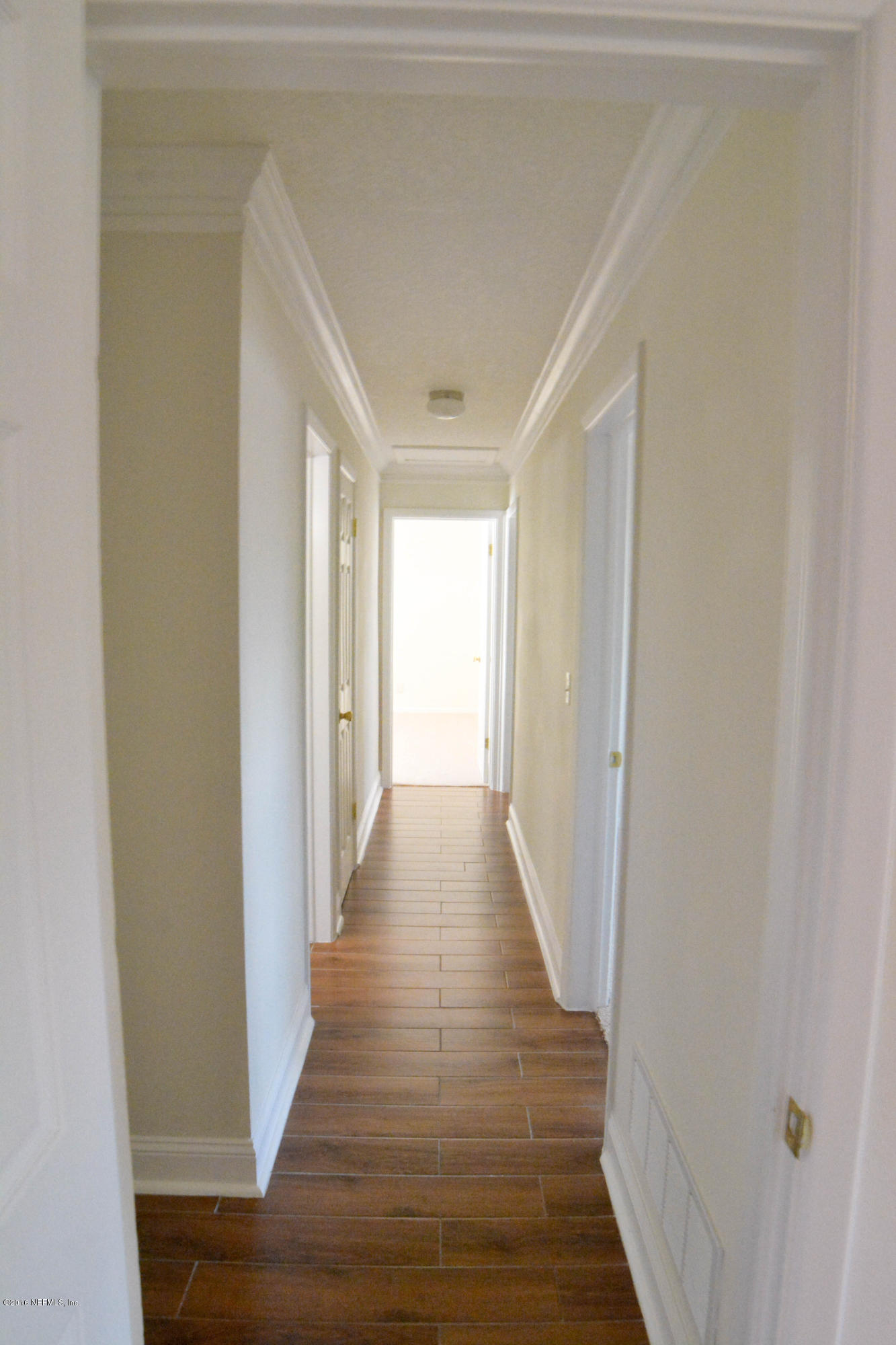 6717 West Fincannon Road Jacksonville, FL 32277 - Photo 17 of 32 a view of a hallway with the wooden floor