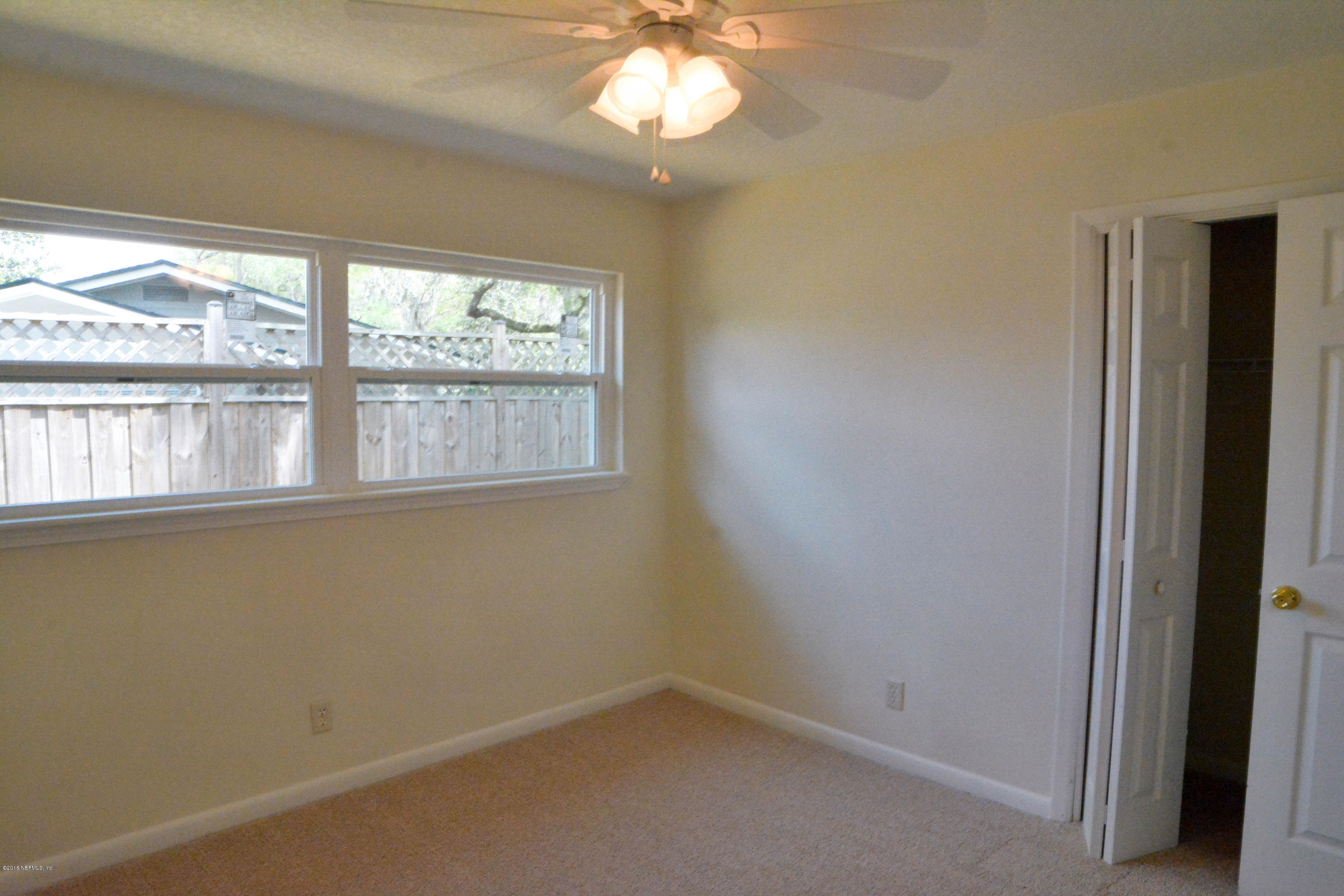 6717 West Fincannon Road Jacksonville, FL 32277 - Photo 18 of 32 an empty room with a window