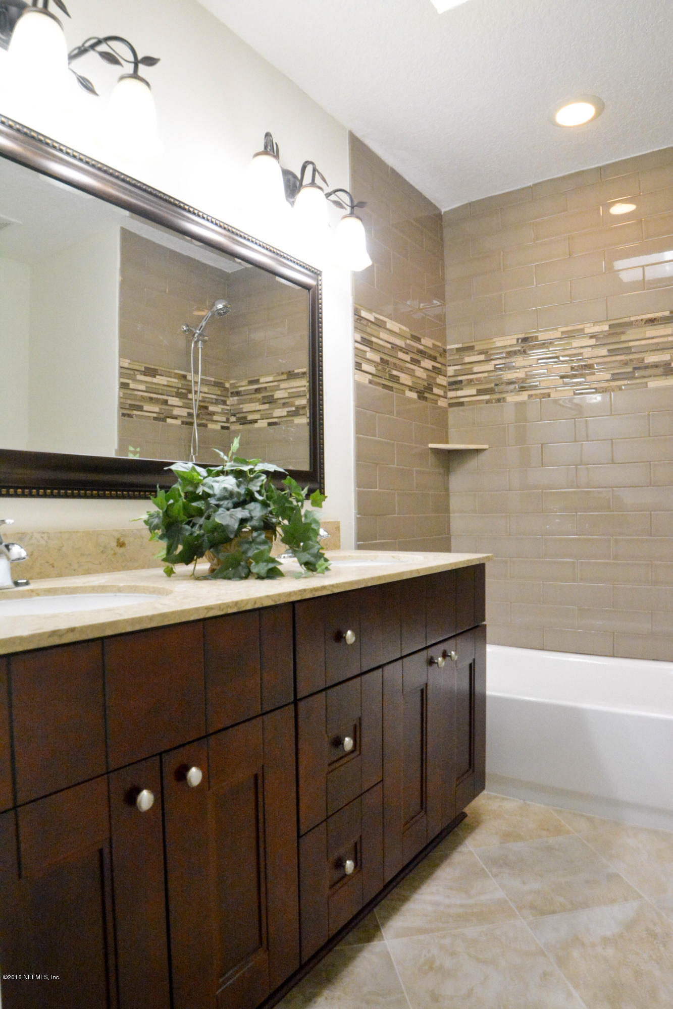 6717 West Fincannon Road Jacksonville, FL 32277 - Photo 20 of 32 a bathroom with a double vanity sink and a large mirror