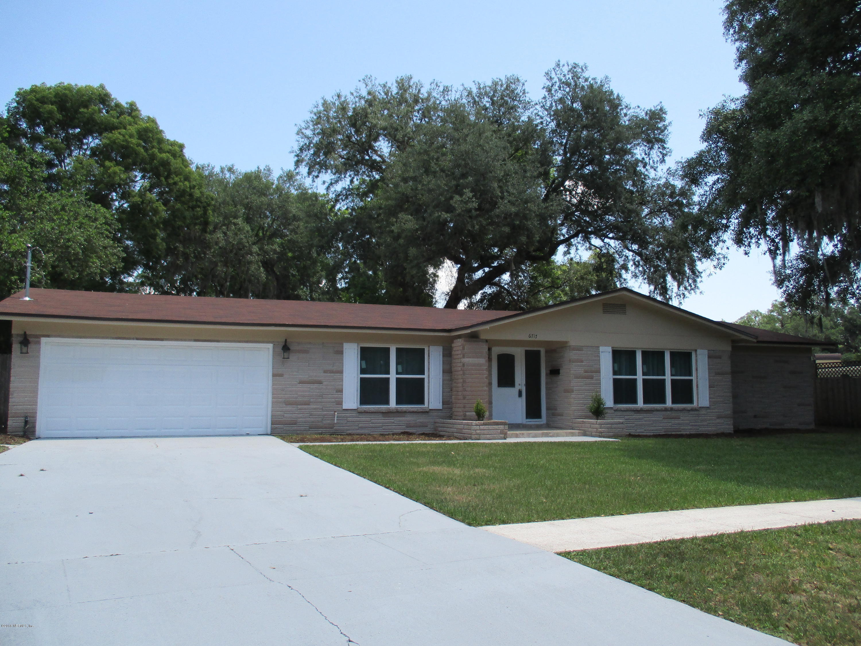 6717 West Fincannon Road Jacksonville, FL 32277 - Photo 2 of 32 a front view of a house with a garden