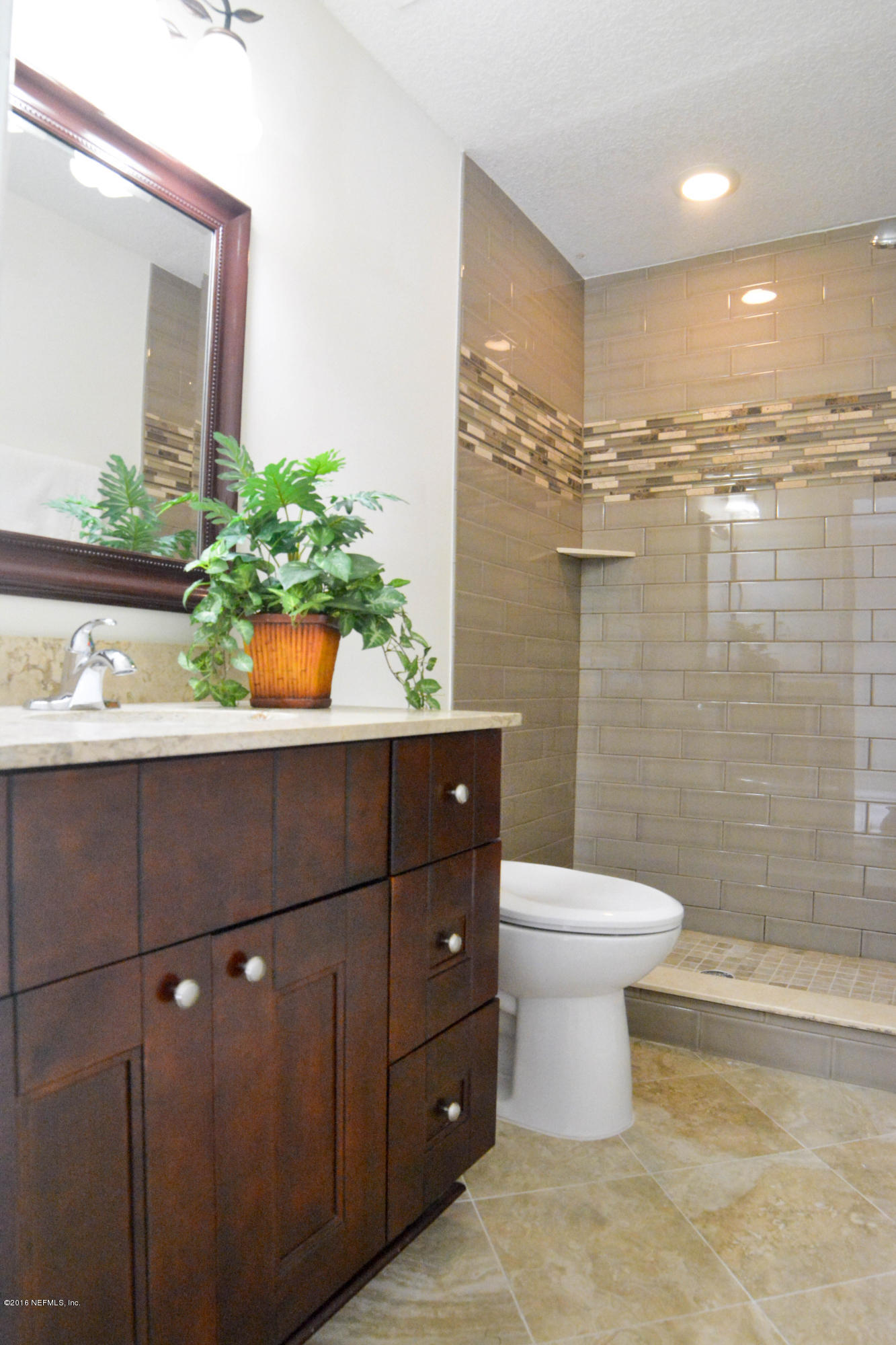 6717 West Fincannon Road Jacksonville, FL 32277 - Photo 24 of 32 a bathroom with a sink a toilet and shower