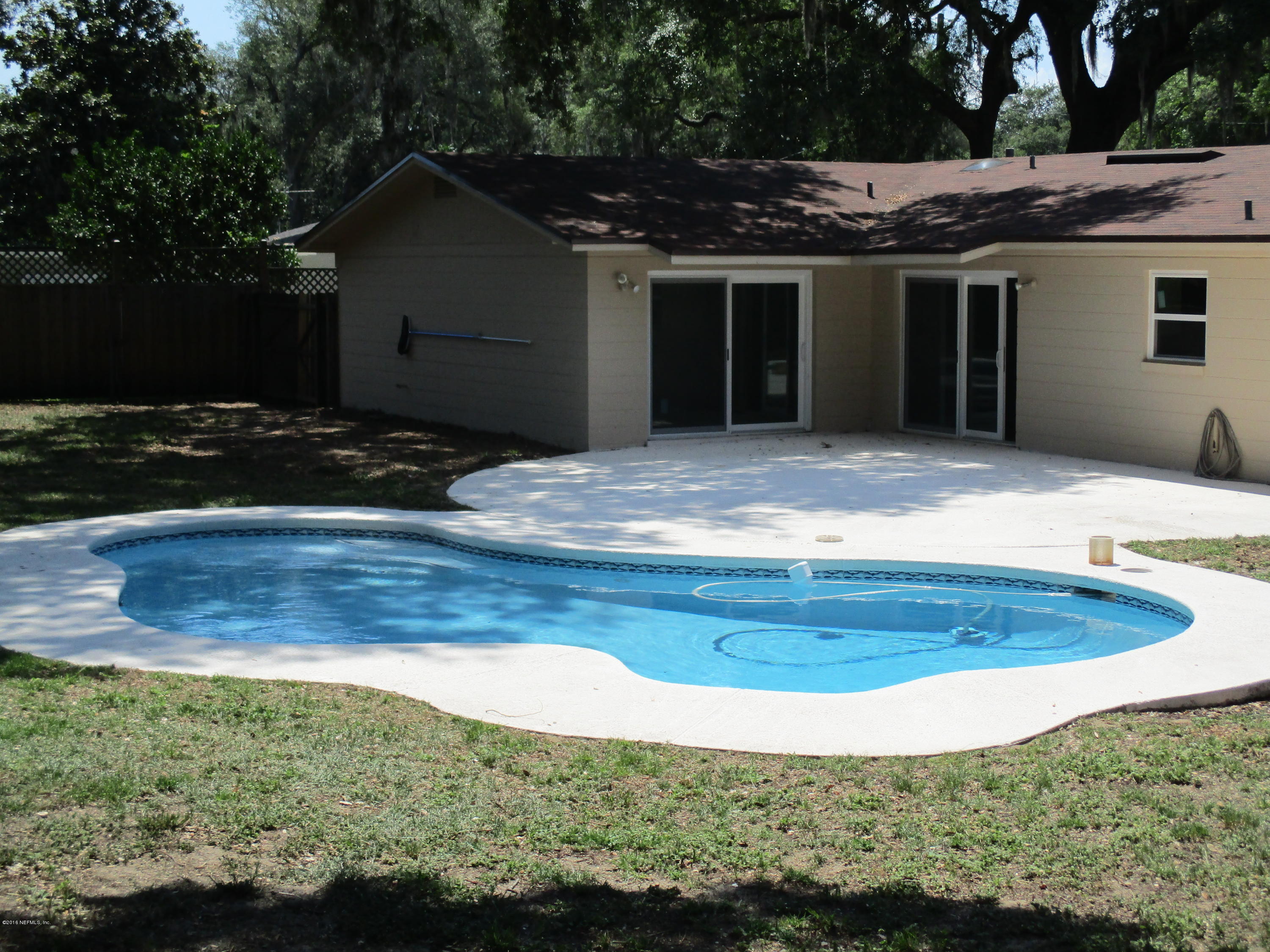 6717 West Fincannon Road Jacksonville, FL 32277 - Photo 25 of 32 a view of house with backyard
