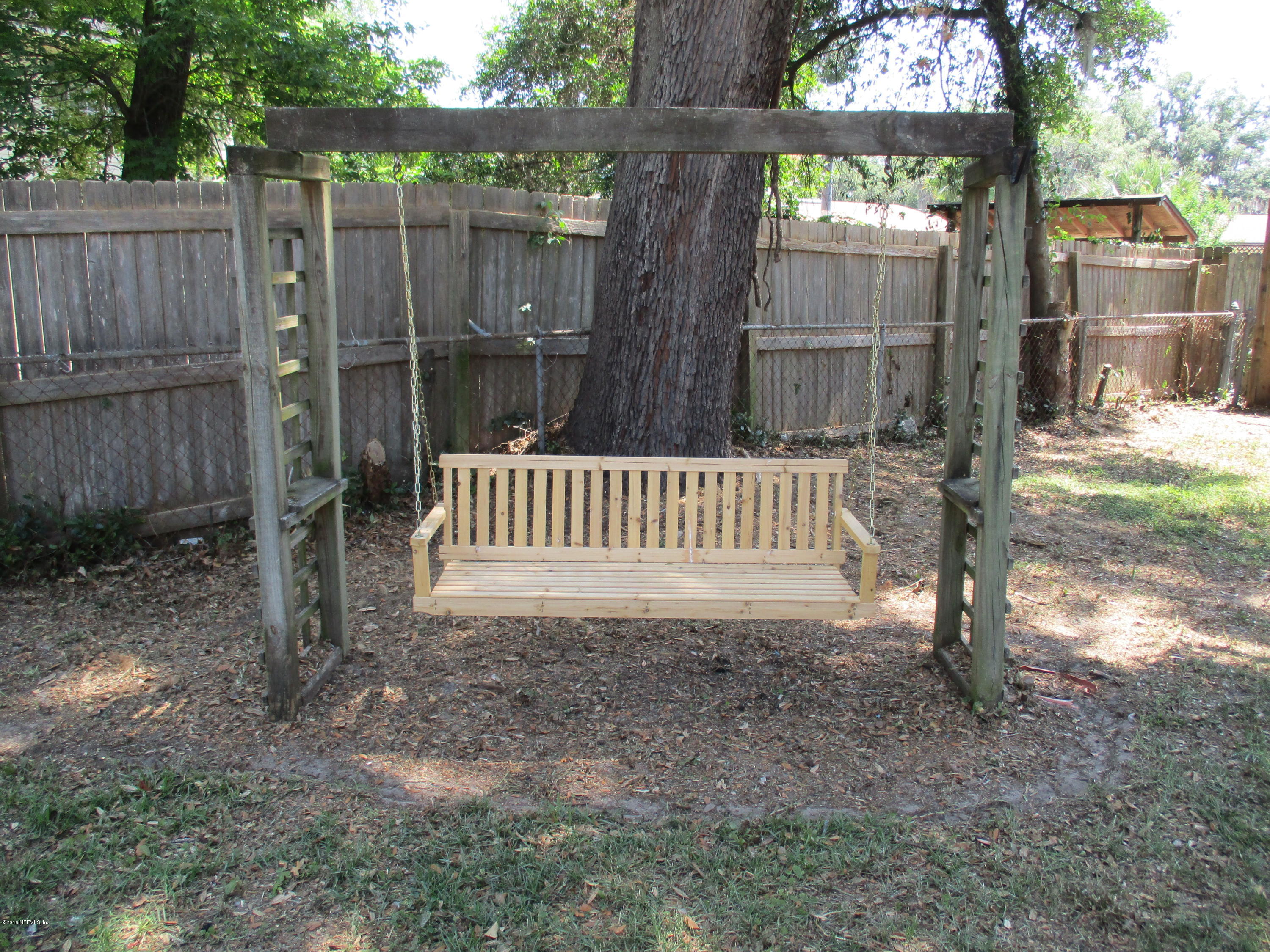 6717 West Fincannon Road Jacksonville, FL 32277 - Photo 27 of 32 a view of a deck with a small yard and wooden fence