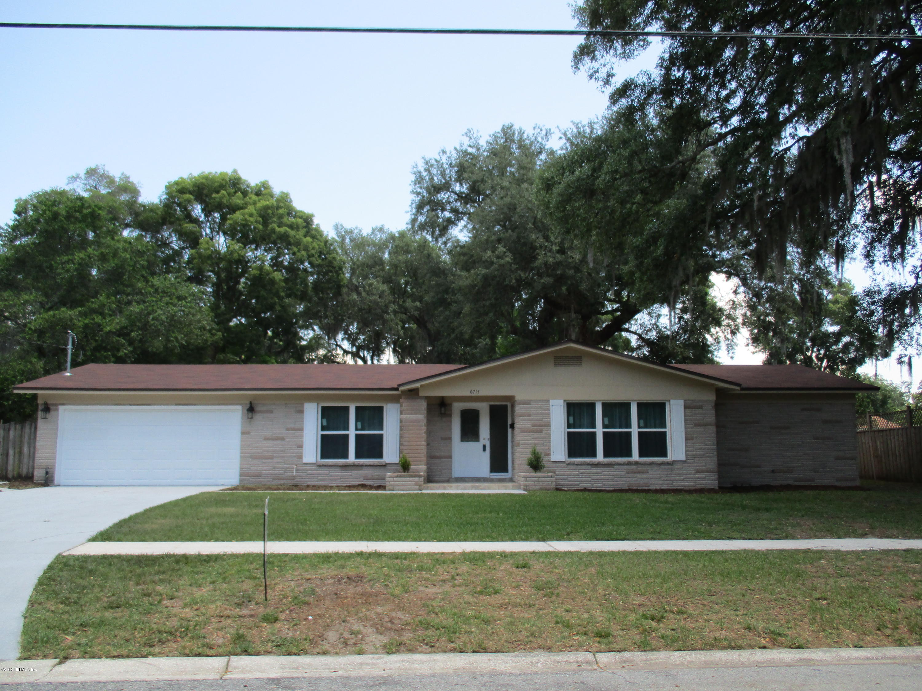 6717 West Fincannon Road Jacksonville, FL 32277 - Photo 3 of 32 a front view of a house with a yard