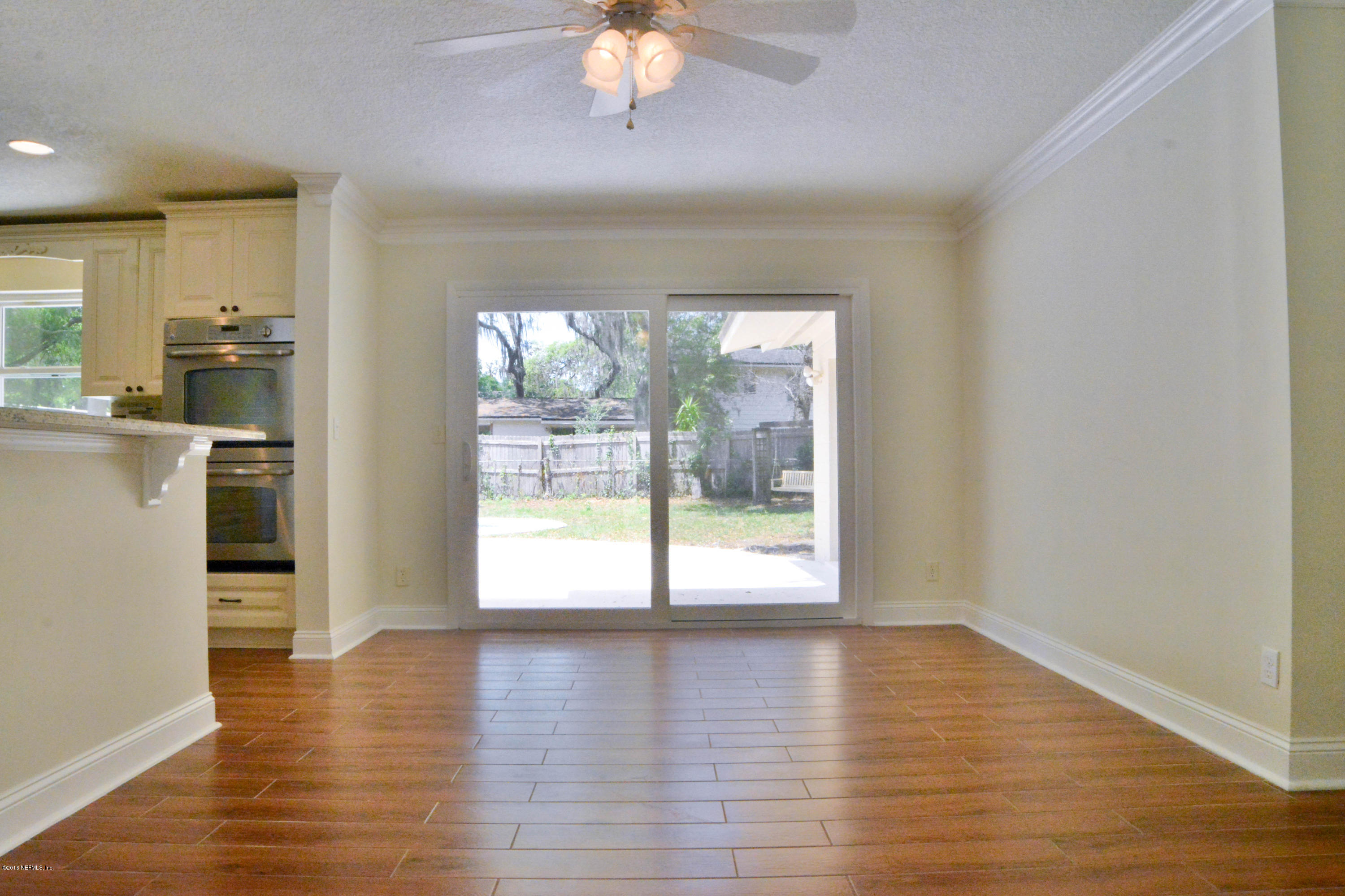 6717 West Fincannon Road Jacksonville, FL 32277 - Photo 8 of 32 a view of a room with wooden floor and a window