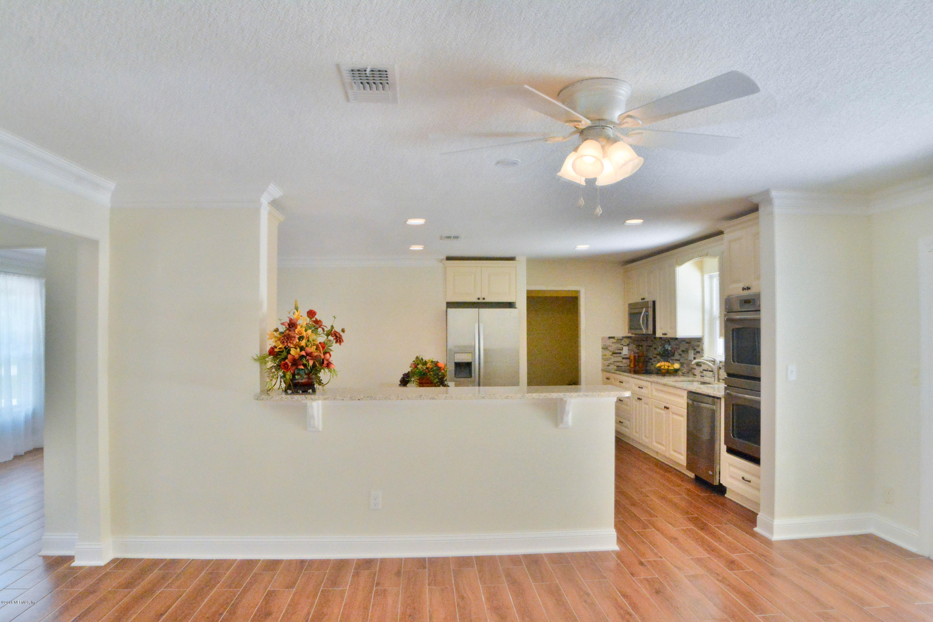 6717 West Fincannon Road Jacksonville, FL 32277 - Photo 9 of 32 a view of a kitchen with a sink a refrigerator and a window
