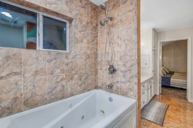 a bathroom with a bathtub and a shower