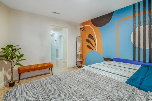 a bedroom with a bed and a chair