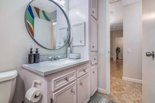 a bathroom with a sink a vanity and a mirror