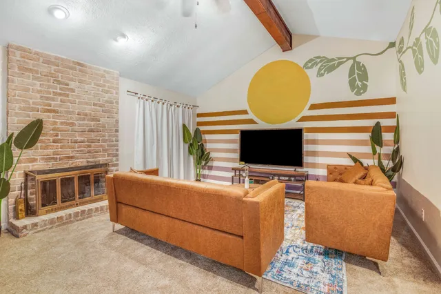 a living room with furniture and a flat screen tv