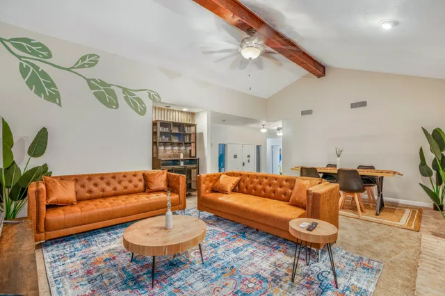 a living room with furniture a rug and a chandelier