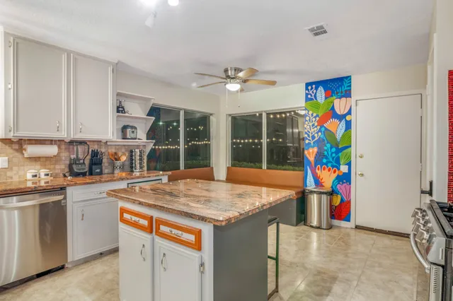 a view of a kitchen with stainless steel appliances granite countertop a sink and a refrigerator