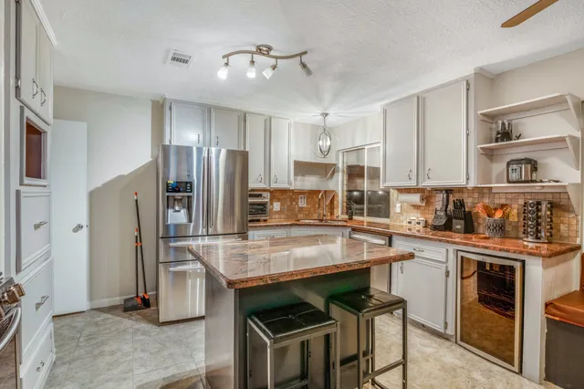 a kitchen with stainless steel appliances a sink stove and refrigerator