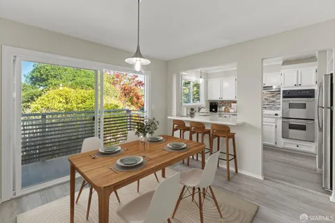 a view of a dining room with furniture window and outside view