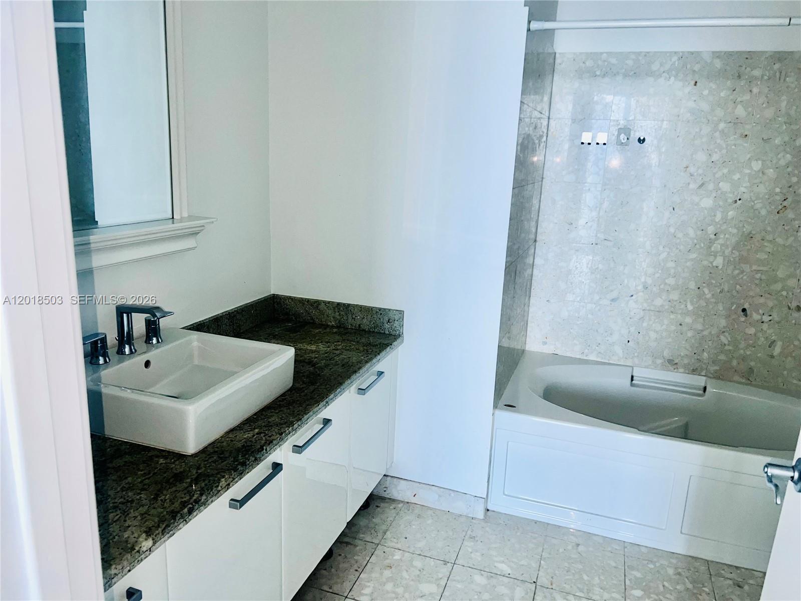 185 Southwest 7th Street, Unit 2805 Miami, FL 33130 - Photo 6 of 6 a bathroom with a sink and a bathtub