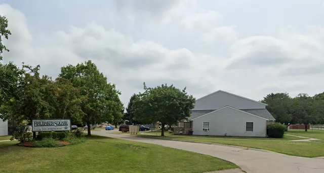 a view of a house with a yard and sitting area