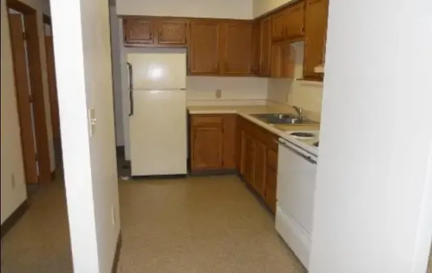 a kitchen with a refrigerator sink and stove