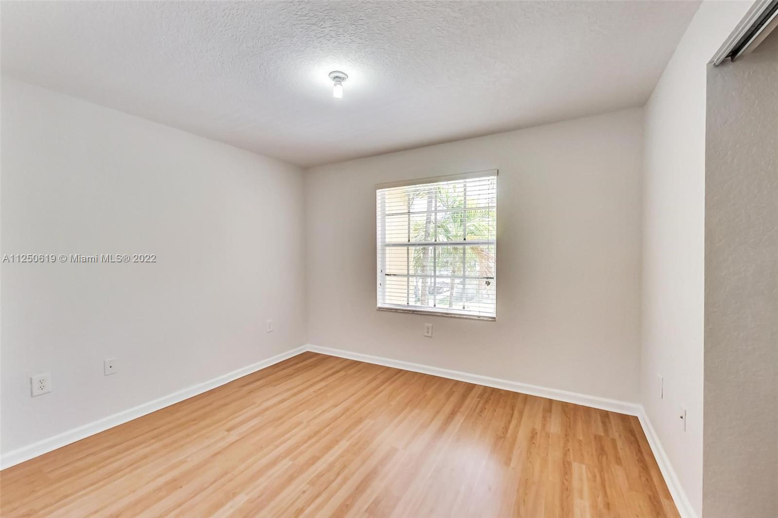 Silver Falls Miramar, FL 33027 - Photo 20 of 38 an empty room with wooden floor and windows