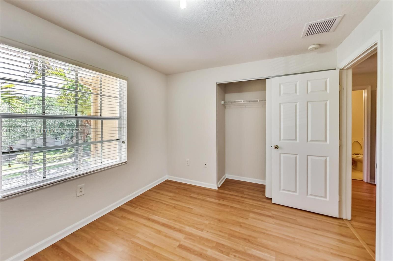 Silver Falls Miramar, FL 33027 - Photo 22 of 38 an empty room with wooden floor and windows
