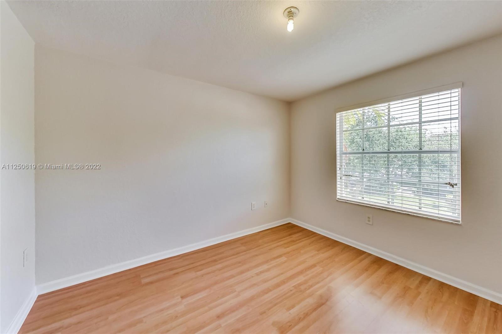 Silver Falls Miramar, FL 33027 - Photo 25 of 38 an empty room with wooden floor and windows