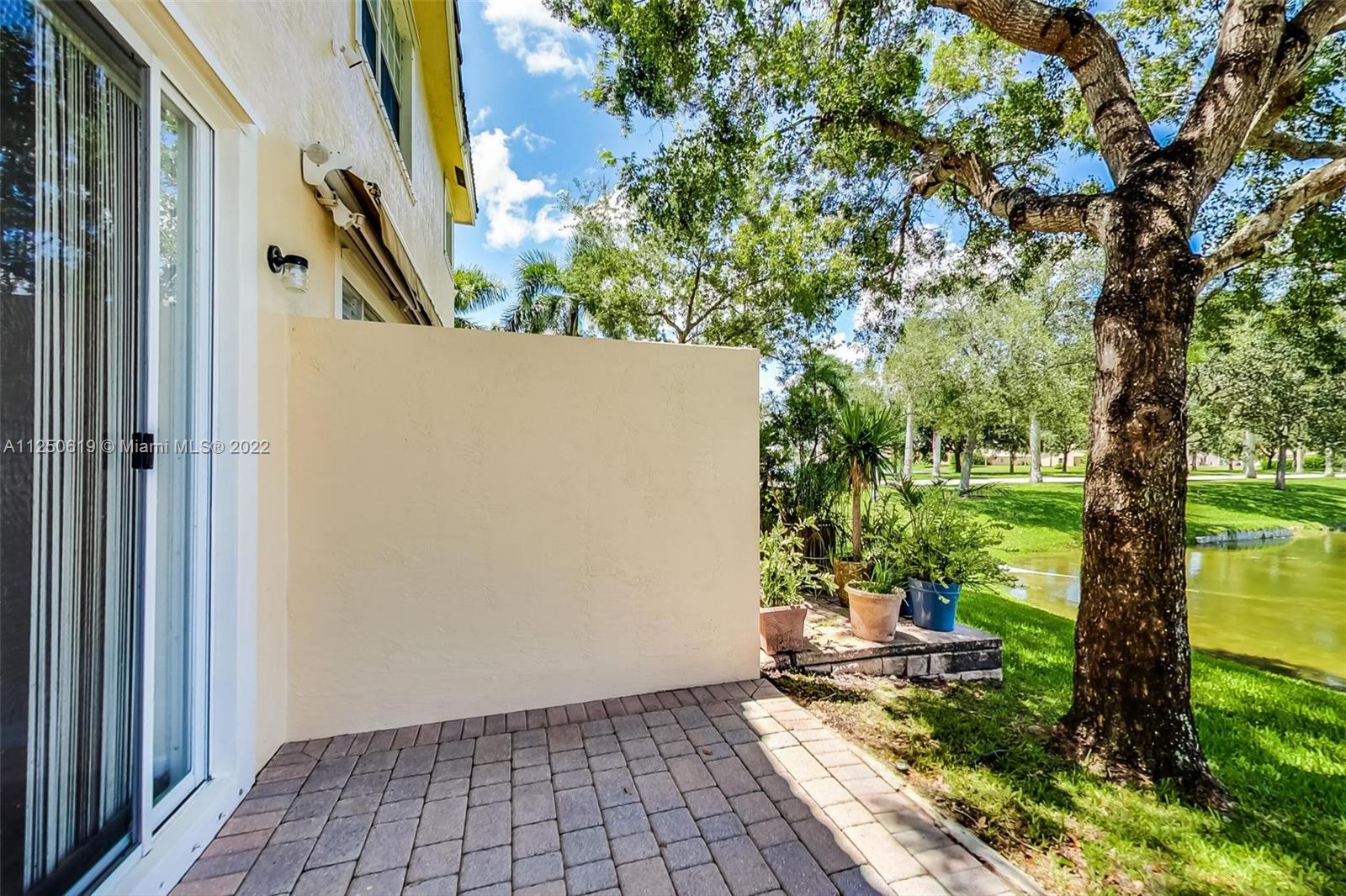 Silver Falls Miramar, FL 33027 - Photo 30 of 38 a porch with a bench in front of a house