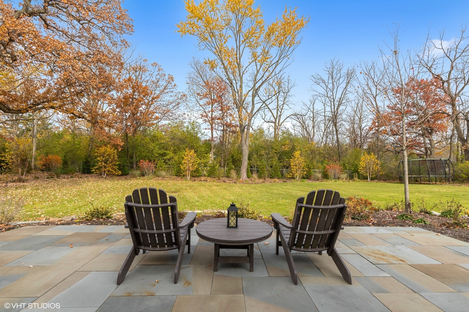 1414 North Avenue Bannockburn, IL 60015 - Photo 26 of 29 a view of a patio with chair and table and chairs under an umbrella