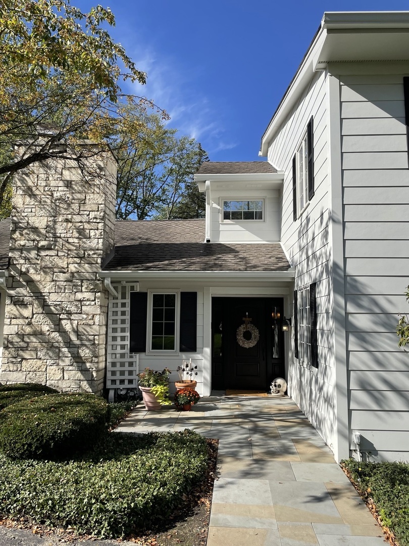 1414 North Avenue Bannockburn, IL 60015 - Photo 4 of 29 a view of a house with potted plants and a yard