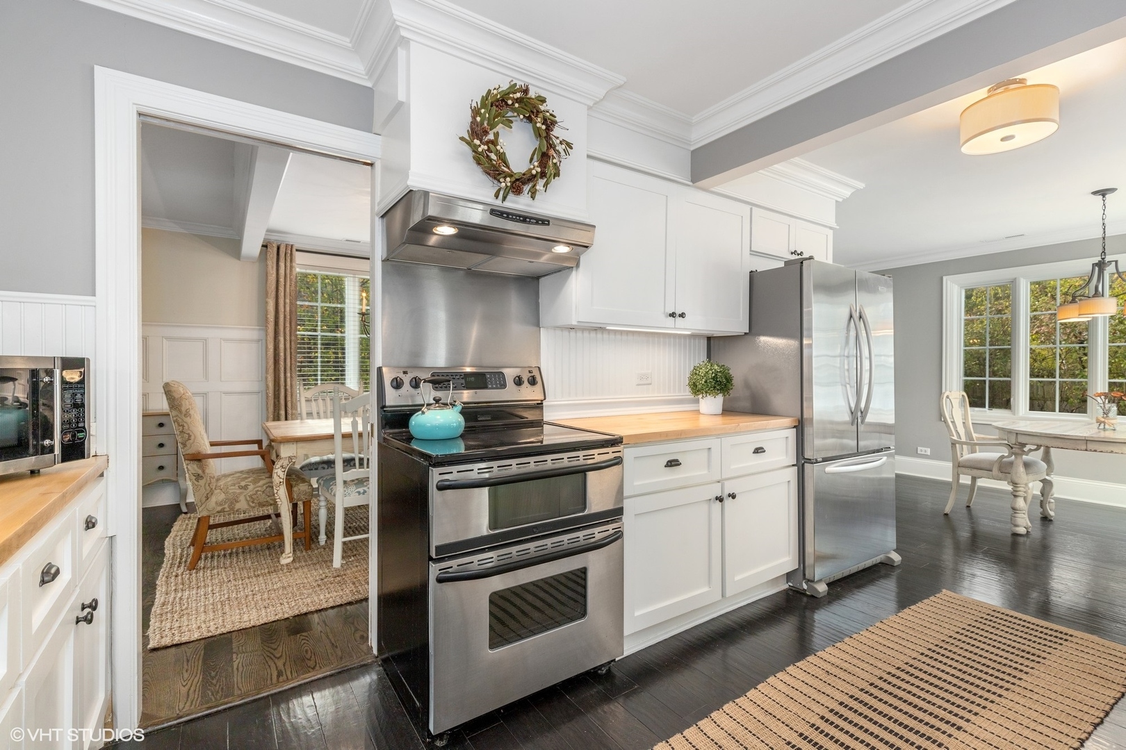 1414 North Avenue Bannockburn, IL 60015 - Photo 9 of 29 a kitchen with stainless steel appliances a stove a sink dishwasher and white cabinets with wooden floor