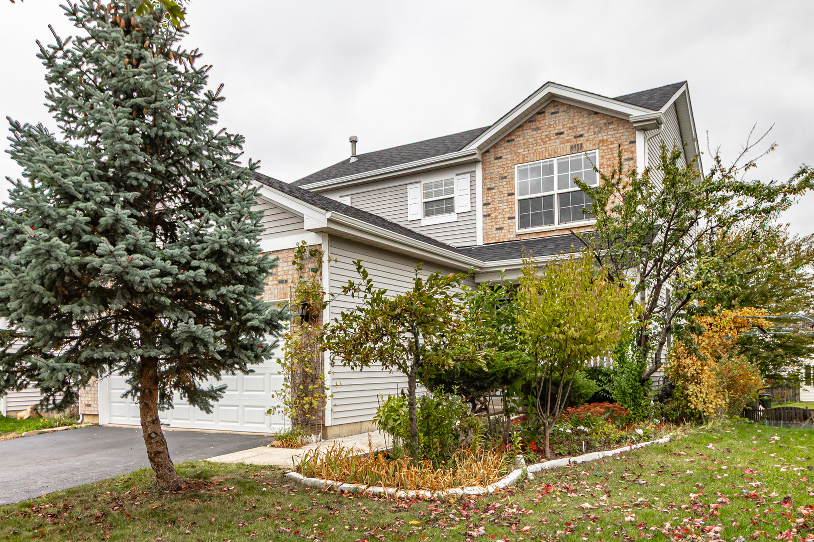 1759 South Fallbrook Drive Round Lake, IL 60073 - Photo 1 of 1 a front view of a house with a yard and garage