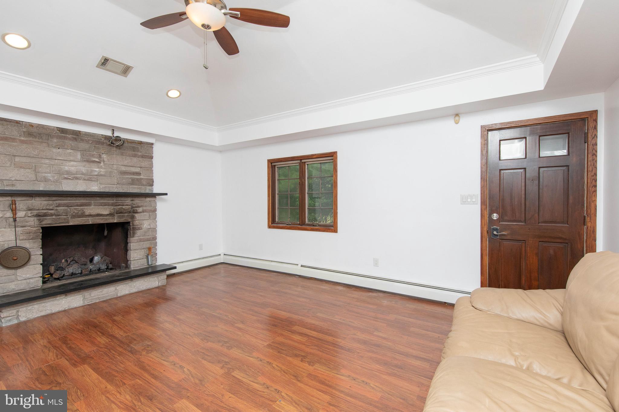 95 Radburn Road Huntingdon Valley, PA 19006 - Photo 11 of 40 a view of an empty room with a fireplace and a window
