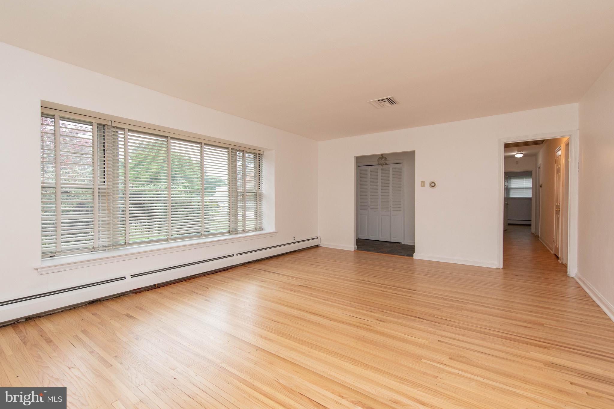 95 Radburn Road Huntingdon Valley, PA 19006 - Photo 14 of 40 a view of an empty room with wooden floor and a window