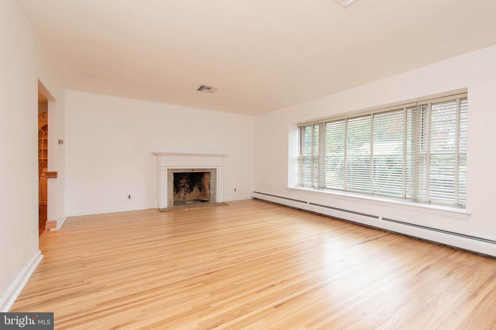 95 Radburn Road Huntingdon Valley, PA 19006 - Photo 16 of 40 wooden floor fireplace and natural light in room