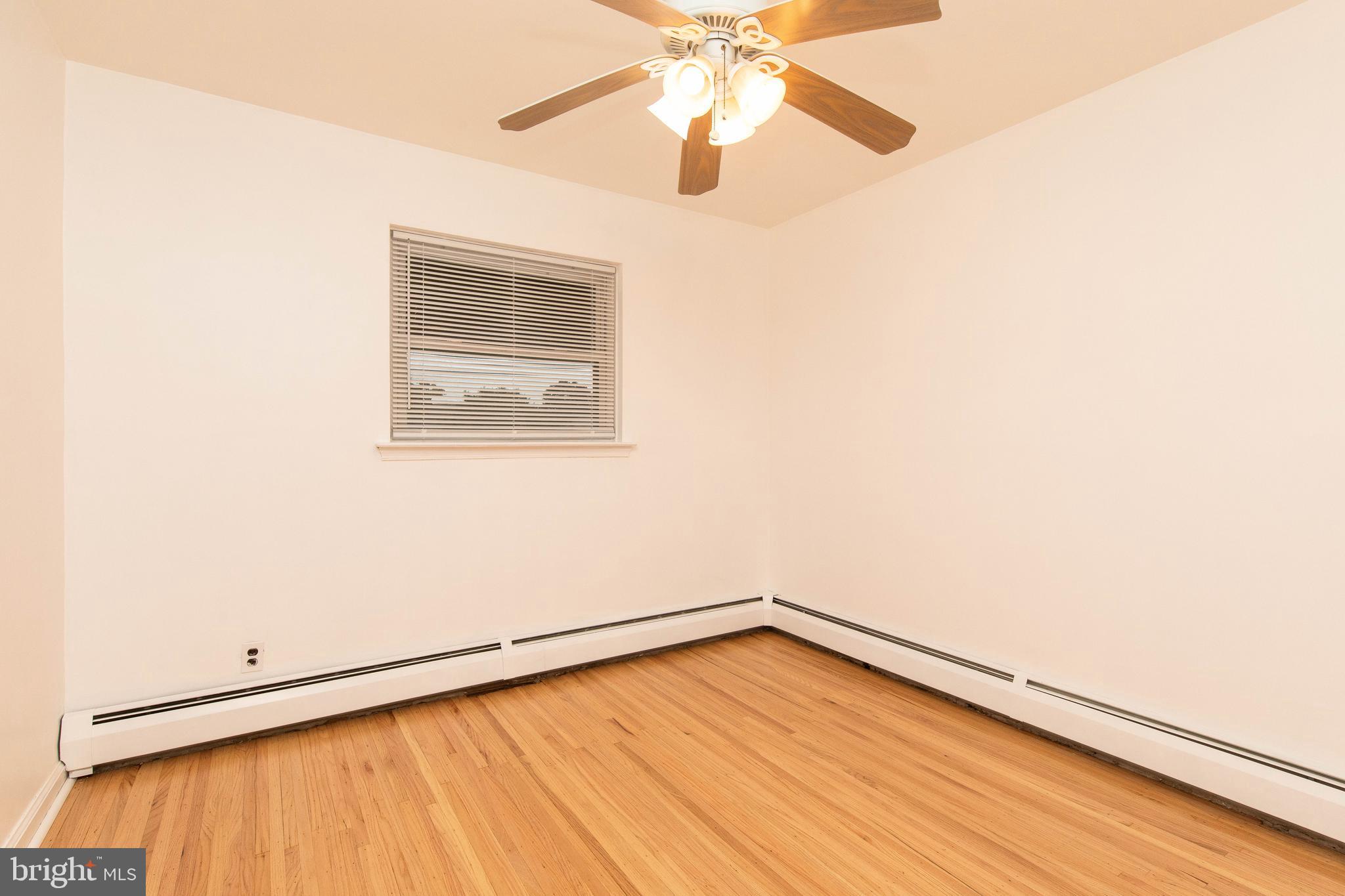 95 Radburn Road Huntingdon Valley, PA 19006 - Photo 23 of 40 an empty room with a window and wooden floor