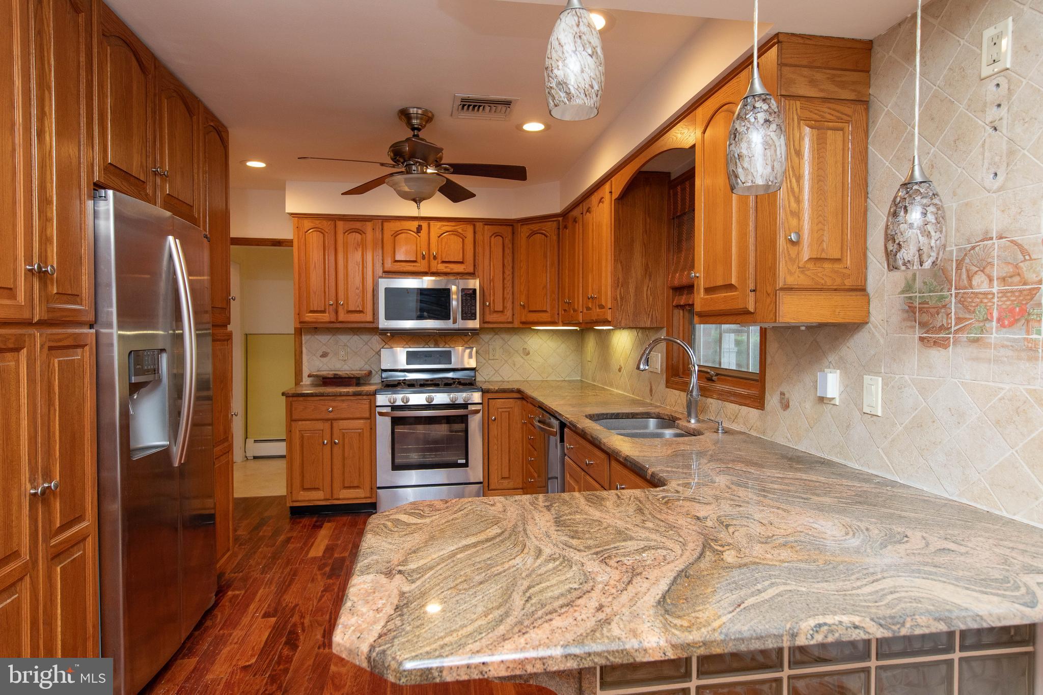 95 Radburn Road Huntingdon Valley, PA 19006 - Photo 4 of 40 a kitchen with stainless steel appliances granite countertop a refrigerator a sink and a stove