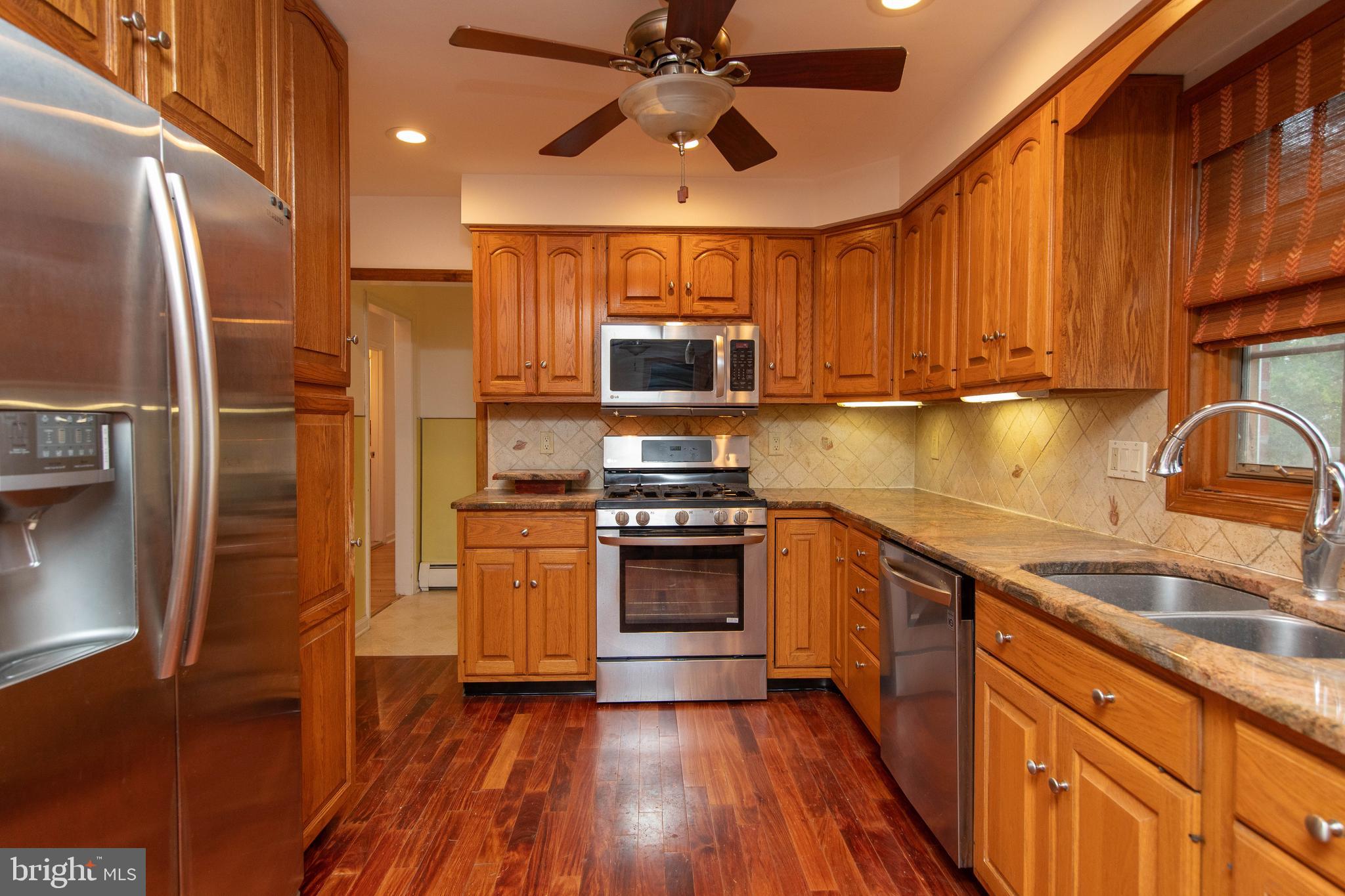 95 Radburn Road Huntingdon Valley, PA 19006 - Photo 8 of 40 a kitchen with stainless steel appliances granite countertop a stove refrigerator and a sink