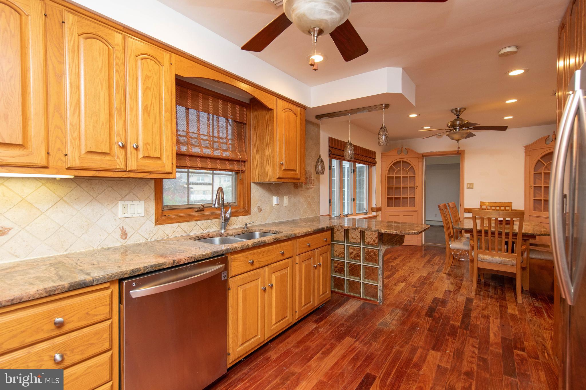 95 Radburn Road Huntingdon Valley, PA 19006 - Photo 9 of 40 a kitchen with lots of counter top space and dining table