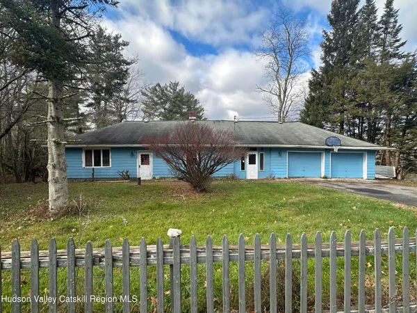 a front view of house with yard and trees