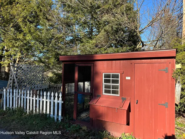 a backyard of a house with barbeque oven and outdoor seating