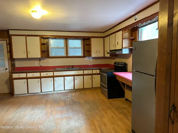 a kitchen with a refrigerator and a more cabinets