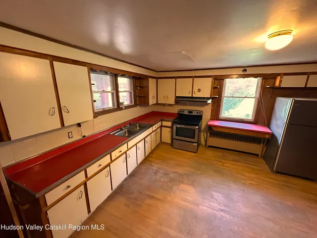 a view of front door with furniture and a window