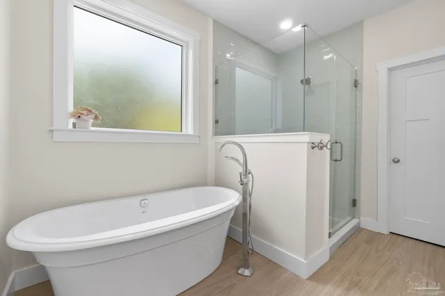 a white bath tub sitting next to a white sink
